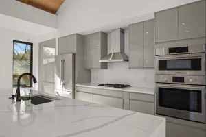 Newly renovated kitchen in Austin, Texas. White marble countertops, ergonomic and upgraded kitchen appliances, and minimalistic cabinets.
