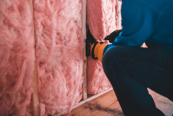 a home builder installing home insulation