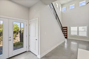 Custom staircase includes a closet by the backyard sliding doors.