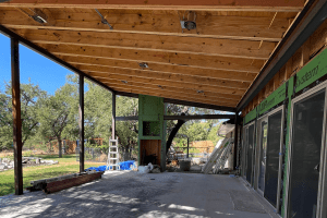 Cedar Park Freccia Group project progress picture of patio renovation. Close up of wooden beams under patio roof.