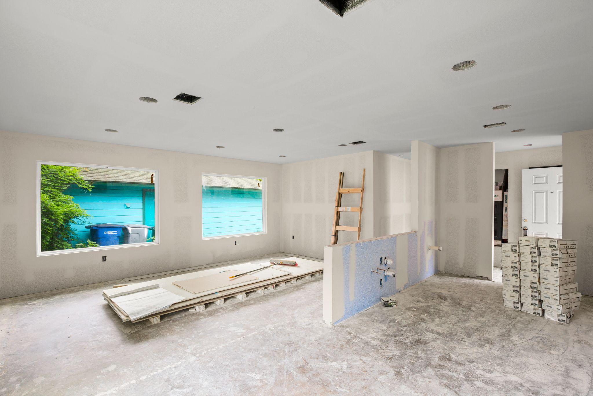 The interior of a custom home being built in Austin showing the drywall after it's been hung. 