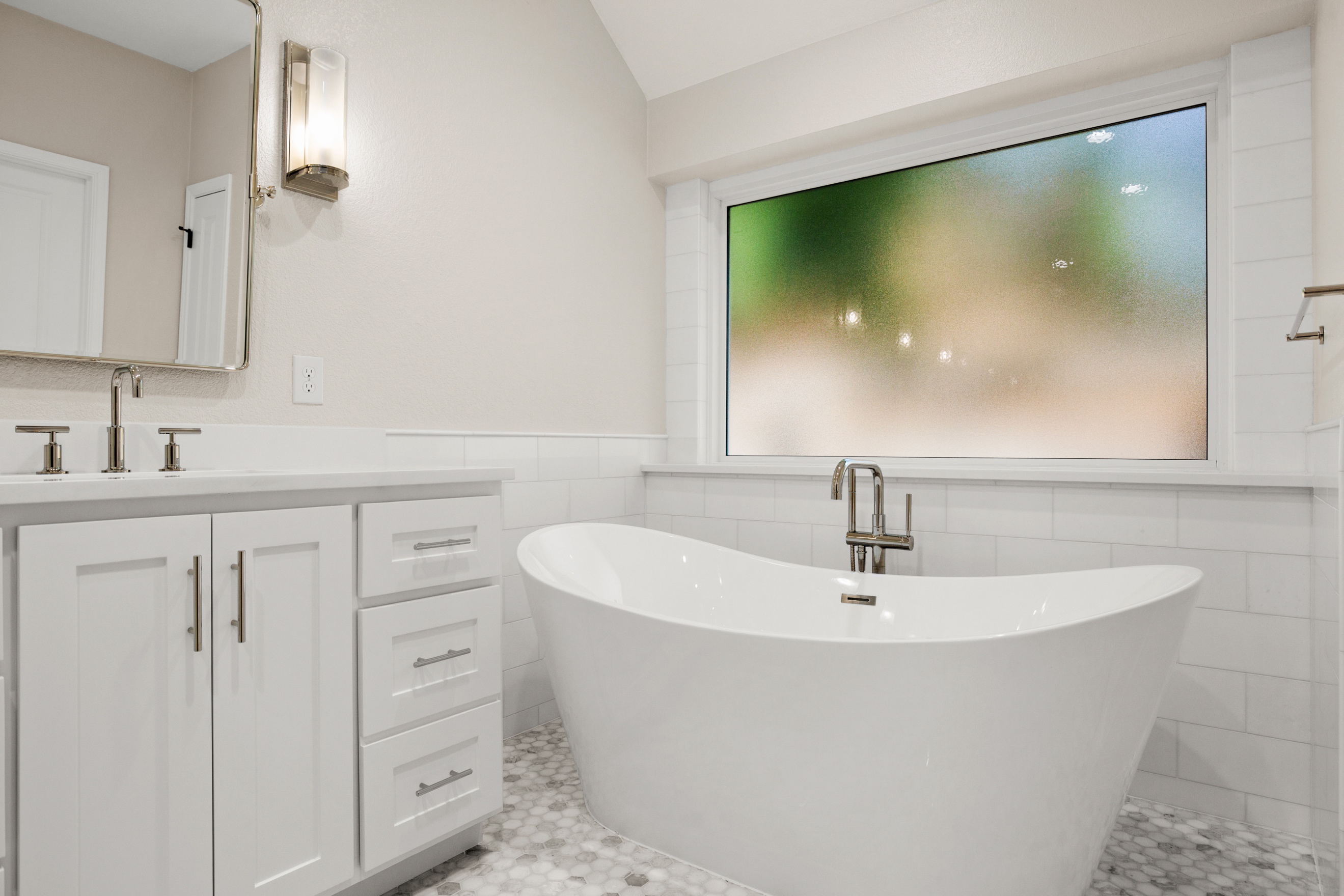 A stand-alone bathtub in a vintage bathroom renovation.