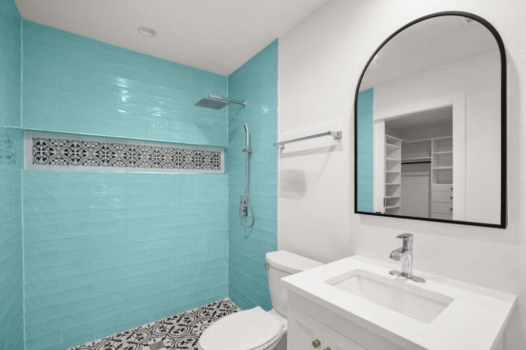 An accessible bathroom renovation with walk-in shower space, and a toilet.