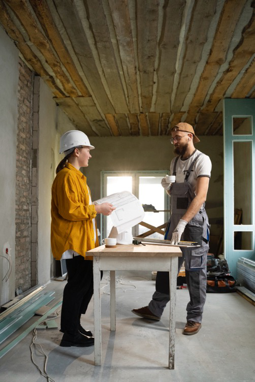 custom home builders talking to each other in a room that’s under construction