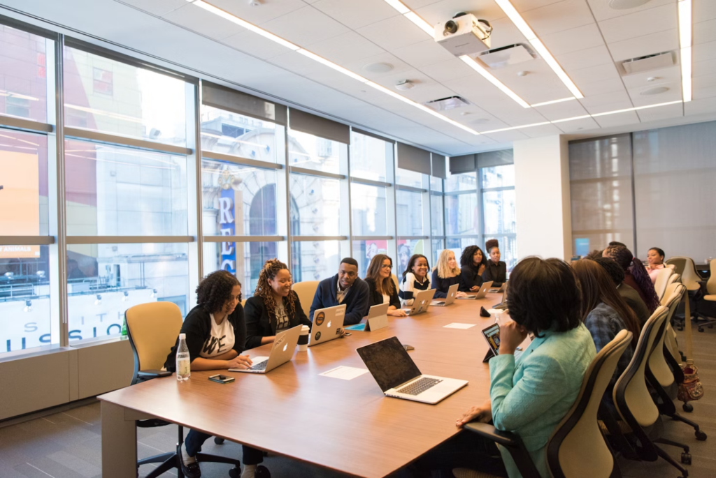 People attending a meeting with their laptops in a conference room 