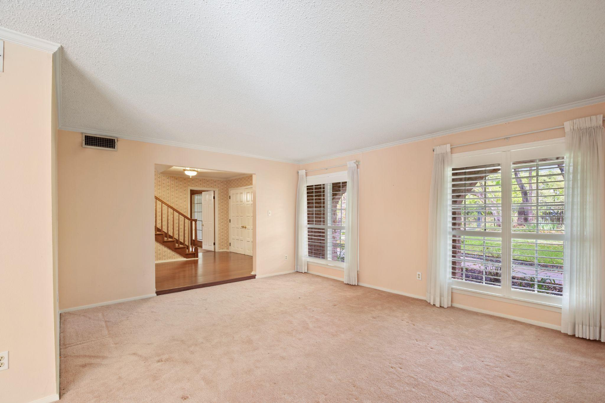 The interior of a house with stairs and windows designed by custom home builders