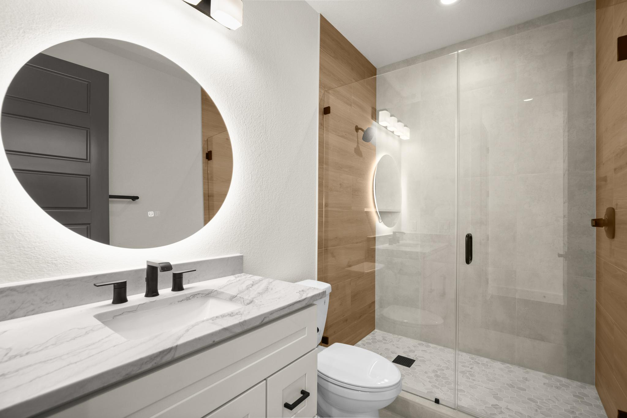 A bathroom remodeling project with a mirror, sink, toilet, and shower