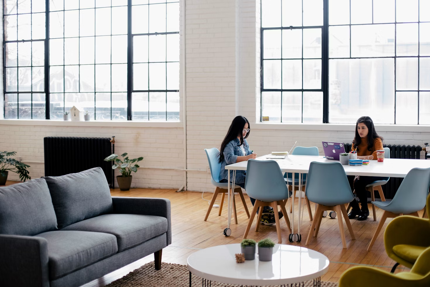  People working on the table inside a workspace designed by office remodelers in Georgetown 