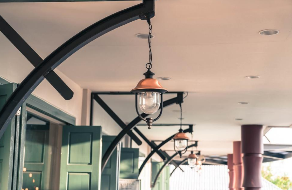 a retail store exterior with hanging brass lamps