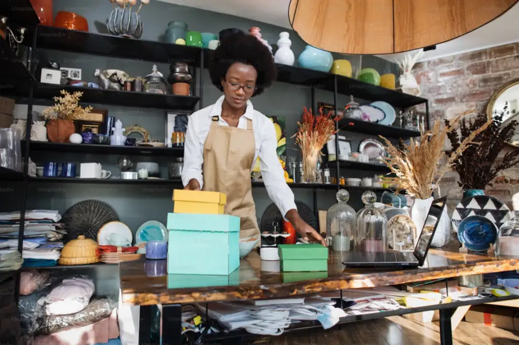 A person arranging things and boxes in a retail store