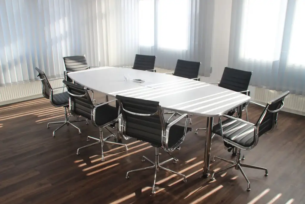 A meeting room with table and chairs