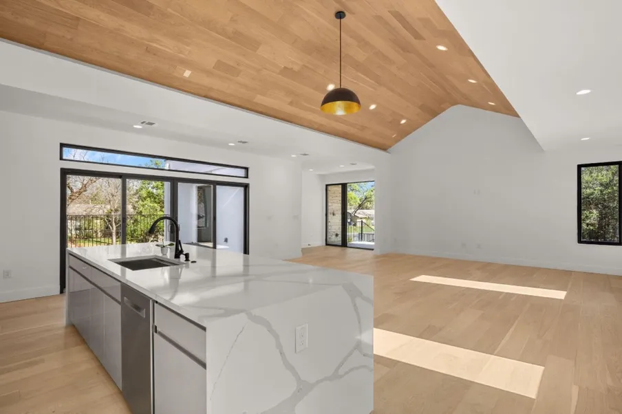 A kitchen design and layout with a kitchen island and a light.