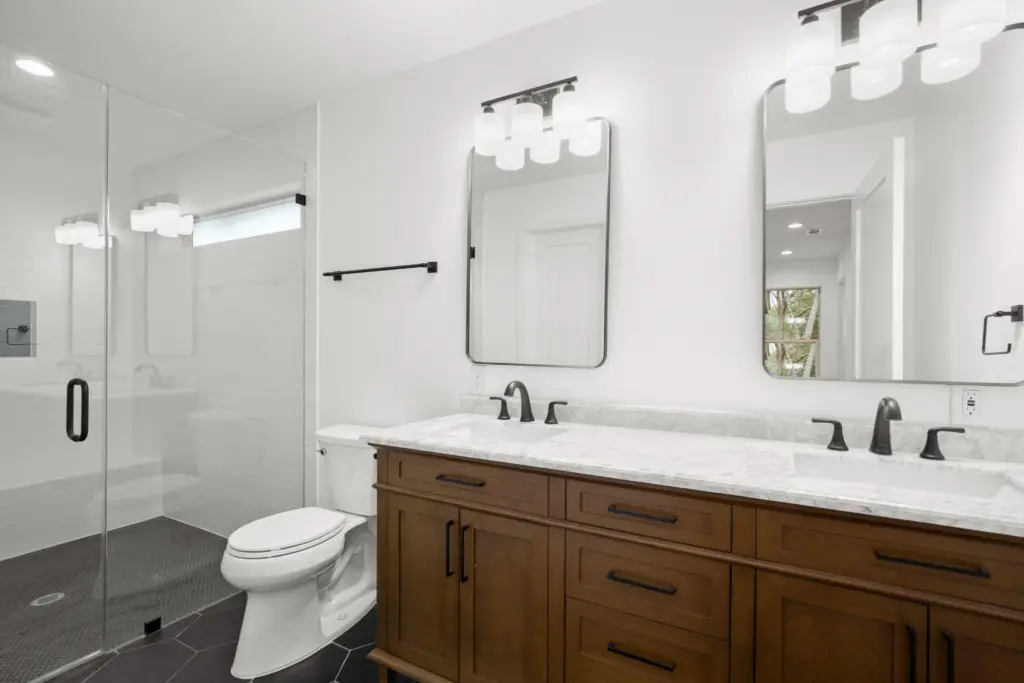 A bathroom remodeling project with a cabinet, drawers, mirror, sink, toilet, and shower