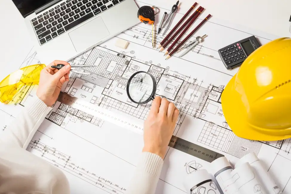 A person inspects the blueprints for an office build-out