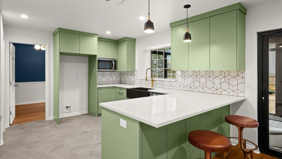 A kitchen renovation project featuring green cabinets