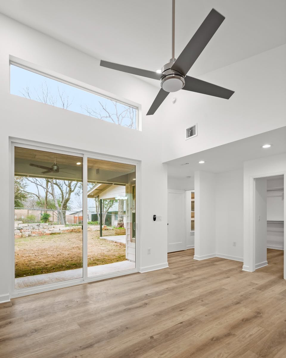 A home addition with wood floors and a ceiling fan