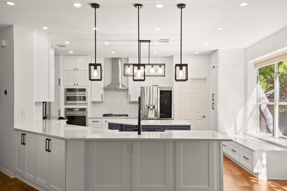 A kitchen remodeling project showing island, updated appliances, and updated fixtures as well as storage ideas.