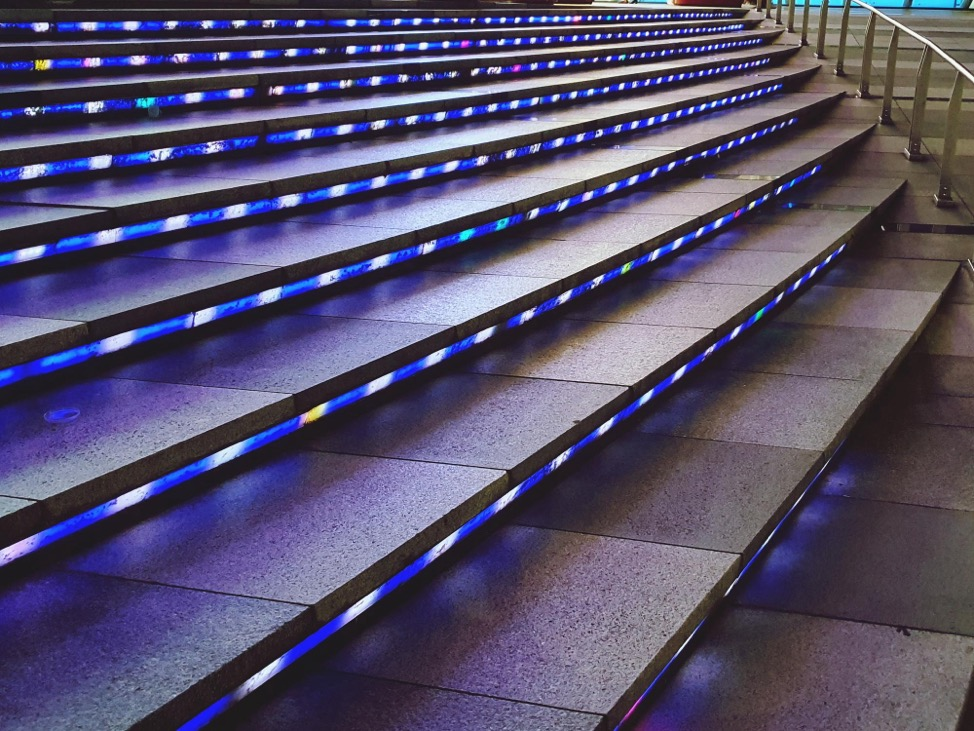 Stairs to a commercial property with underlighting. 