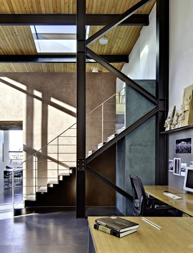 A stairway in a modern commercial space with exposed steel beams